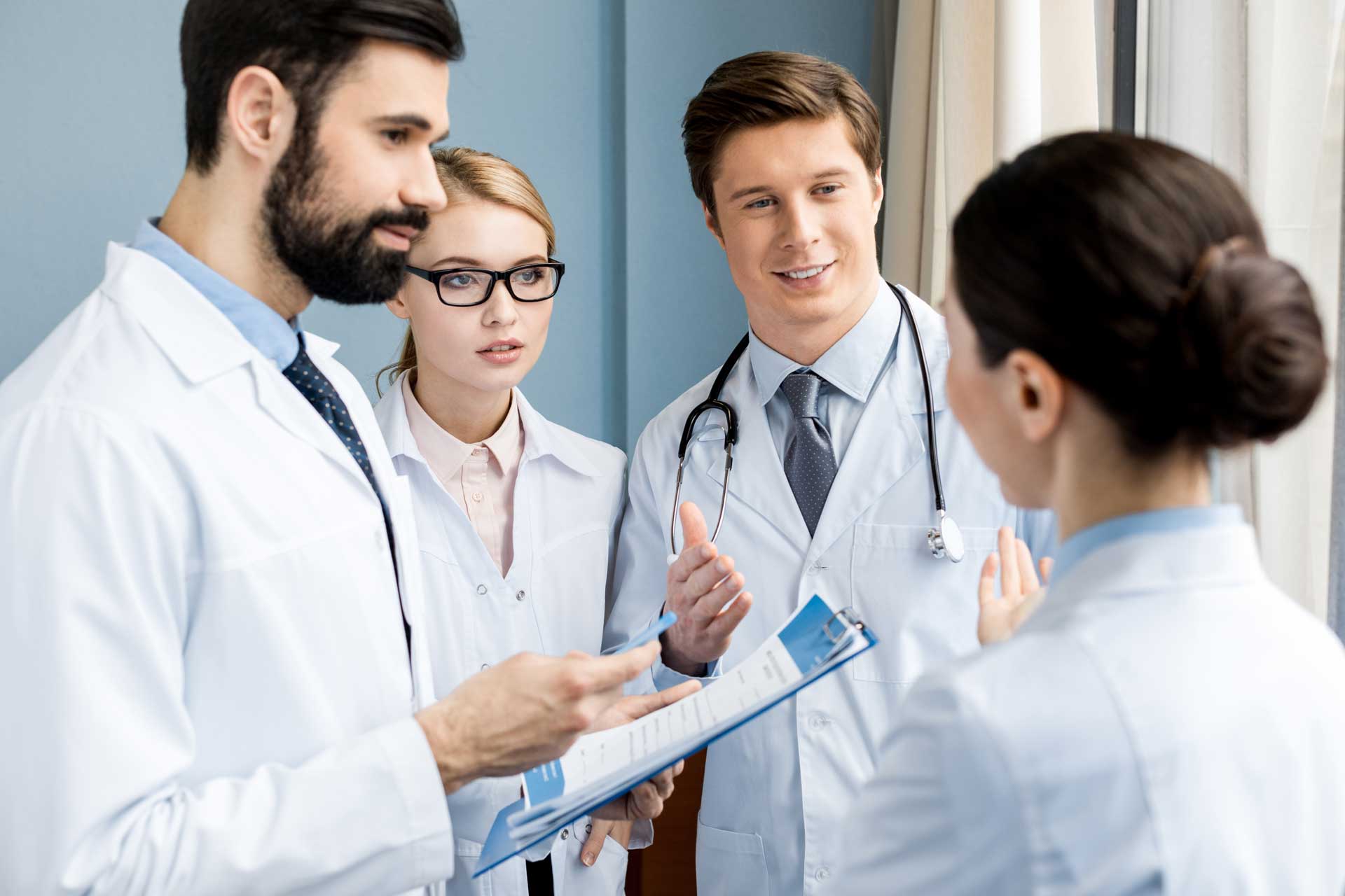 side-view-of-doctors-team-discussing-diagnosis-in-H9FJMNX.jpg